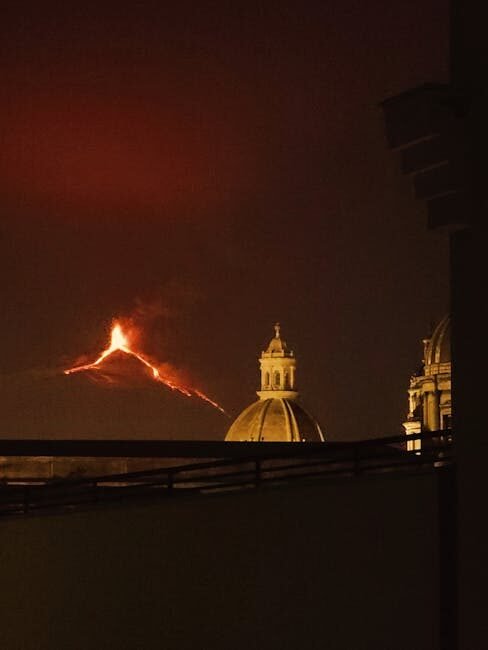 Captivating night view of Mount Etna erupting from a vantage point in Catania, Sicily.